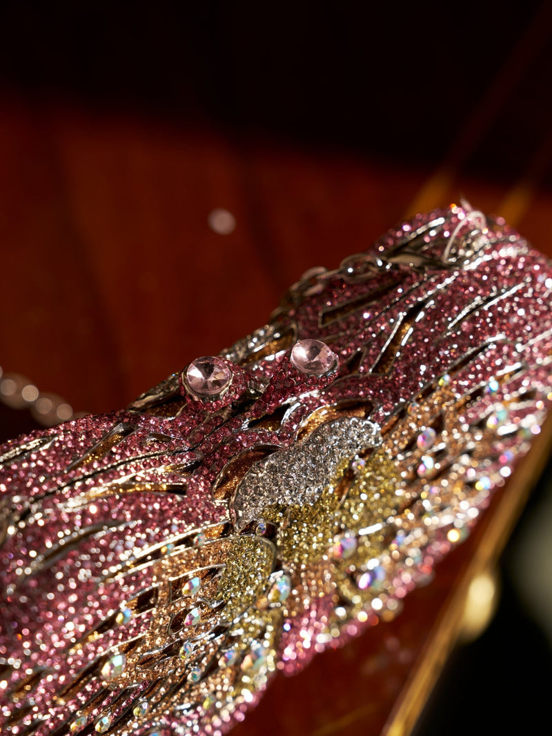 Close-up of the Ombré Crystal Butterfly Mini Bag by Social Queen, adorned with pink and gold crystals, metallic accents, and a rhinestone butterfly clasp—an exquisite and unique accessory for weddings.
