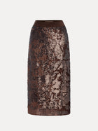 The Ombre Sequin Velvet Skirt by Social Queen is a knee-length brown skirt featuring a fitted waistband, ombré sequins, and a textured, shimmering pattern.