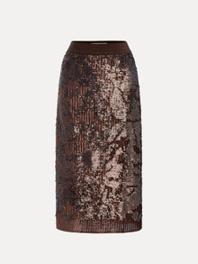 The Ombre Sequin Velvet Skirt by Social Queen is a knee-length brown skirt featuring a fitted waistband, ombré sequins, and a textured, shimmering pattern.