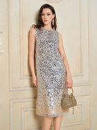 A woman in the Social Queen Ombre Silver & Gold Sequin Embellished Dress stands by a textured beige wall, accessorized with a gold beaded handbag and long drop earrings.