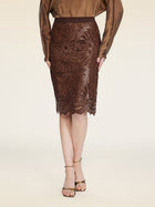 A person wearing a brown long-sleeve top, the Social Queen Openwork Embroidered Leather Skirt, and beige heeled sandals stands against a neutral background.
