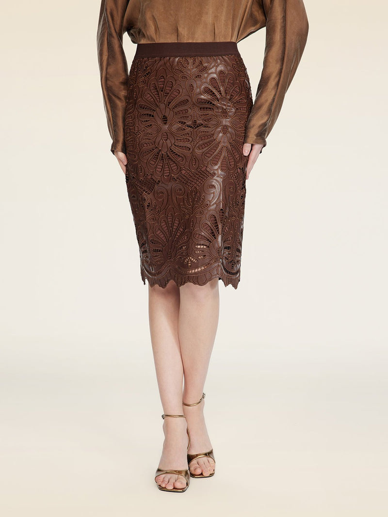 A person wearing a brown long-sleeve top, the Social Queen Openwork Embroidered Leather Skirt, and beige heeled sandals stands against a neutral background.
