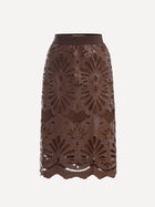The Social Queen Openwork Embroidered Leather Skirt features brown leather with hand-embroidered floral cutouts and a wavy hem, shown against a white background.