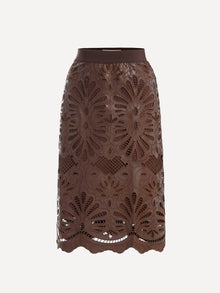 The Social Queen Openwork Embroidered Leather Skirt features brown leather with hand-embroidered floral cutouts and a wavy hem, shown against a white background.