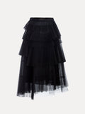 The Social Queen Organza Pleated Skirt in black features tiered hemlines, layered pleats, and a fitted waistband, shown against a white background.