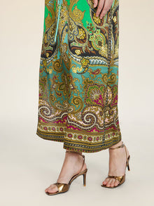 A person in the Social Queen Paisley Printed Silk Satin Dress and metallic open-toe heels stands against a light background.