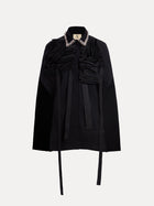 The Social Queen Pearl & 3D Floral Couture Cape features couture craftsmanship with textured ruffle detailing, long neck ties, and a pearl-embellished collar, shown against a plain white background.