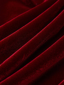 Close-up of the Pearl & Crystal Velvet Blazer by Social Queen, featuring deep red velvet with a soft texture, diagonal folds, and gentle highlights for a touch of vintage glamour.