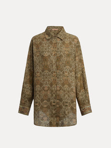 The Social Queen Printed Linen Blouse is a long-sleeve button-up shirt with an olive green hue, crafted from linen and adorned with intricate floral and geometric prints, plus decorative details on the collar and cuffs.
