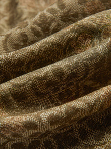 Close-up of textured fabric with brown patterns and visible folds, used for Social Queen’s Printed Linen Straight-Leg Pants.