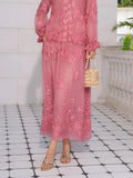 A person wears the Social Queen Rose Appliqué 100% Mulberry Silk Skirt, paired with gold sandals and a beige beaded handbag, standing on a tiled floor beside a white wall and balustrade.