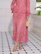 A person wears the Social Queen Rose Appliqué 100% Mulberry Silk Skirt, paired with gold sandals and a beige beaded handbag, standing on a tiled floor beside a white wall and balustrade.