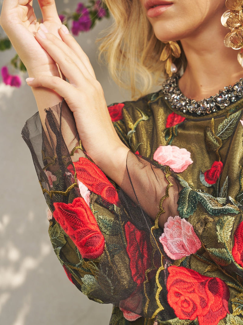 A woman models the Social Queen Rose Embroidered Beaded A-Line Dress, featuring sheer sleeves and a crystal-beaded neckline, shown from the shoulders up.