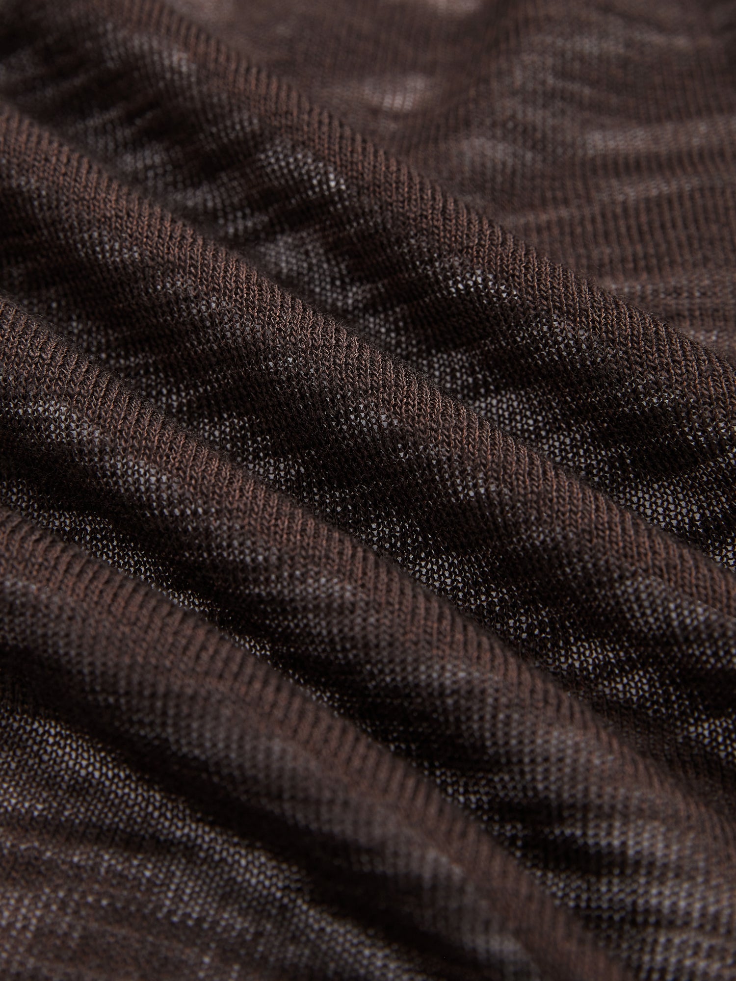 Close-up of brown ribbed fabric with a textured, wavy pattern, ideal for the Rose-Tie Neck Knit Cardigan by Social Queen. Perfect for creating a modern sleeveless or cropped fitted look.