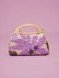 The Social Queen Sequin Embroidered Wooden Handle Bag features purple floral sequin embroidery arranged delicately on a pink background.