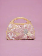 The Social Queen Sequin Embroidered Wooden Handle Bag features a straw-effect design with pink and white floral sequin embroidery on a solid pink background.