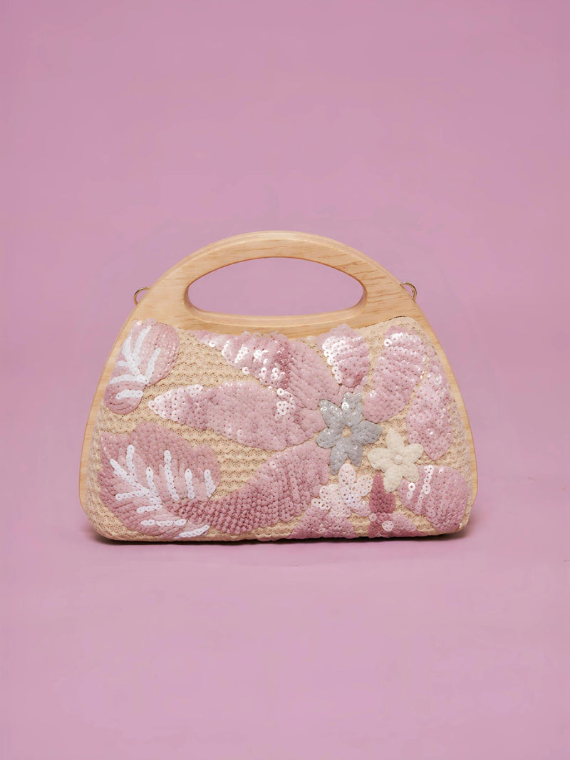 The Social Queen Sequin Embroidered Wooden Handle Bag features a straw-effect design with pink and white floral sequin embroidery on a solid pink background.