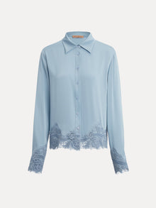 The Social Queen Silk Satin Shirt with Lace Trim features long sleeves and hand-stitched lace on the cuffs and hem, shown here in light blue against a plain white background.
