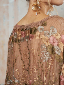 Close-up of a person wearing the Social Queen Square-Neck Embroidered Silk Dress in earthy tones, paired with gold floral earrings featuring a pearl drop.