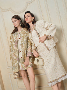 Two women pose indoors in vintage-inspired outfits: one wears the Social Queen Stretch Velvet Camisole with Embossed Lace, layered under a floral coat and dress; the other dons a cream skirt suit with embellishments, holding a matching handbag.