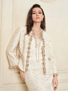 A woman poses against a cream-colored wall wearing the Social Queen Stretch Velvet Camisole with Embossed Lace, styled with layered necklaces.