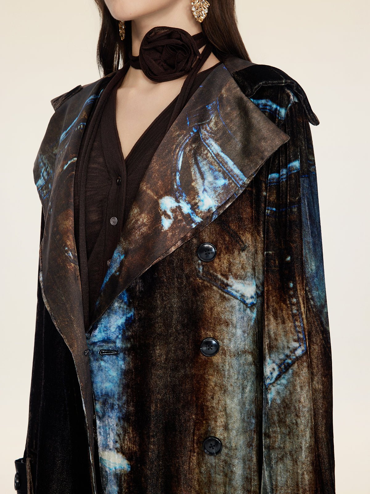 A woman wears the Social Queen Velvet Gradient Tie-Waist Trench Coat over a black top, styled with gold earrings and a fabric choker flower.