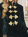 Close-up of a person wearing the Social Queen Velvet Knot-Button Jacket—an emerald velvet blazer with ornate gold knot buttons—making it a stylish choice for wedding guests.