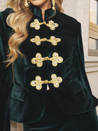 Close-up of a person wearing the Social Queen Velvet Knot-Button Jacket—an emerald velvet blazer with ornate gold knot buttons—making it a stylish choice for wedding guests.