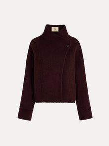The Social Queen Wool-Cashmere Cropped Wrap Jacket features a dark burgundy hue, long sleeves, a collar, an asymmetric front closure, and a single visible button.