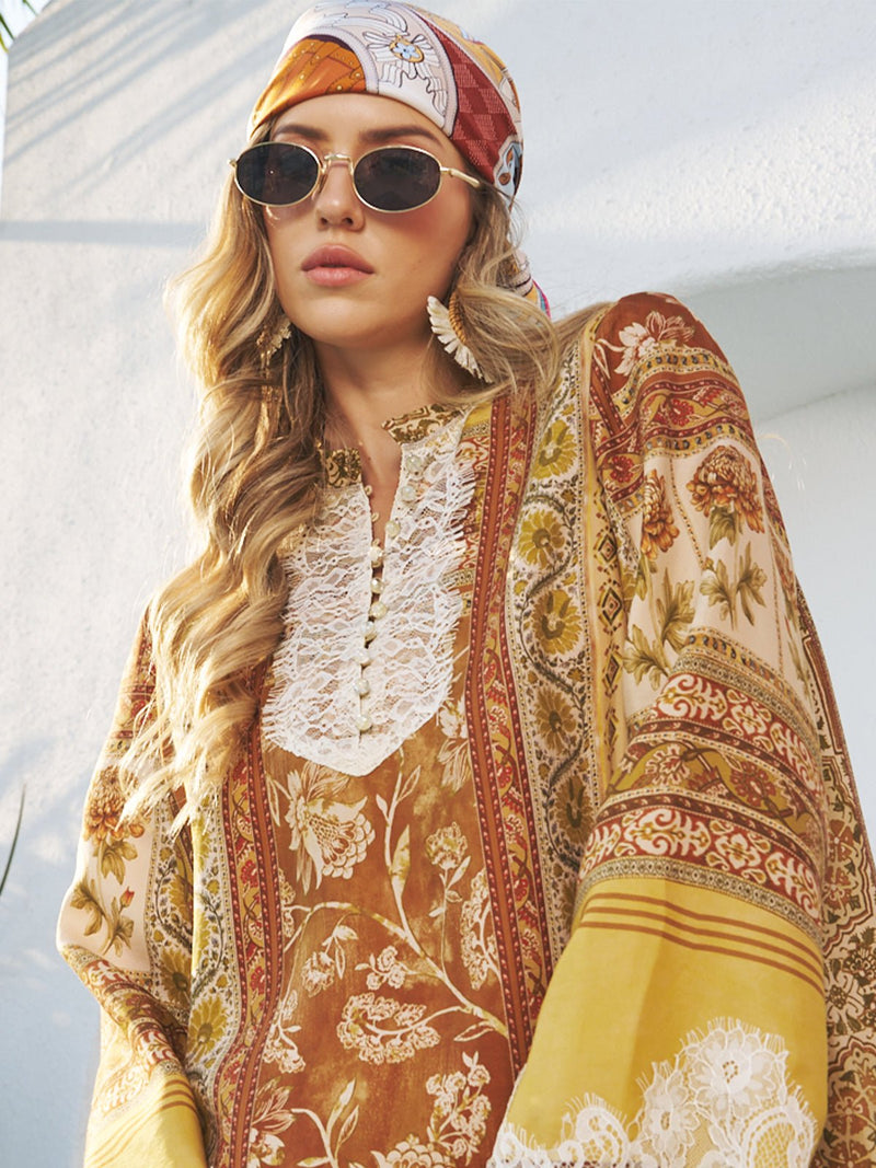 Woman in sunglasses and a headscarf stands against a sunlit white wall, wearing a patterned long-sleeve dress with lace details and accessorized with Social Queen Woven Fan-Shaped Earrings.